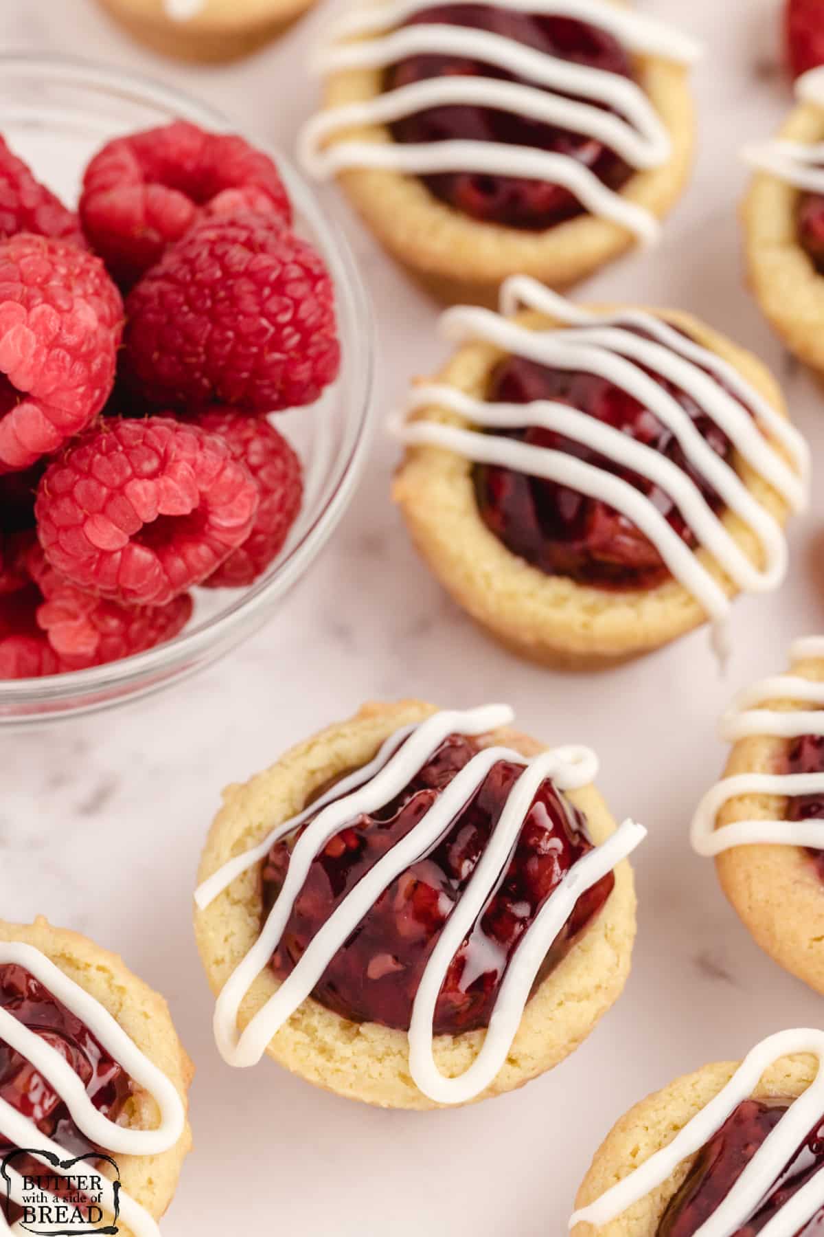 Lemon pudding cookie recipe made in a mini muffin tin with raspberry pie filling
