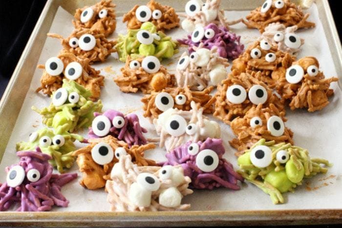 Haunted Haystacks are made from butterscotch chips, peanut butter and marshmallows. Melted and shaped with candy eyeballs for a festive Halloween treat.
