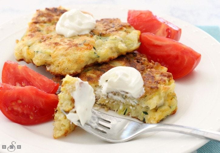 Cheesy Zucchini Fritters are the perfect way to use up some zucchini from your garden! Great as a side dish or appetizer, they're easy to make & flavorful!
