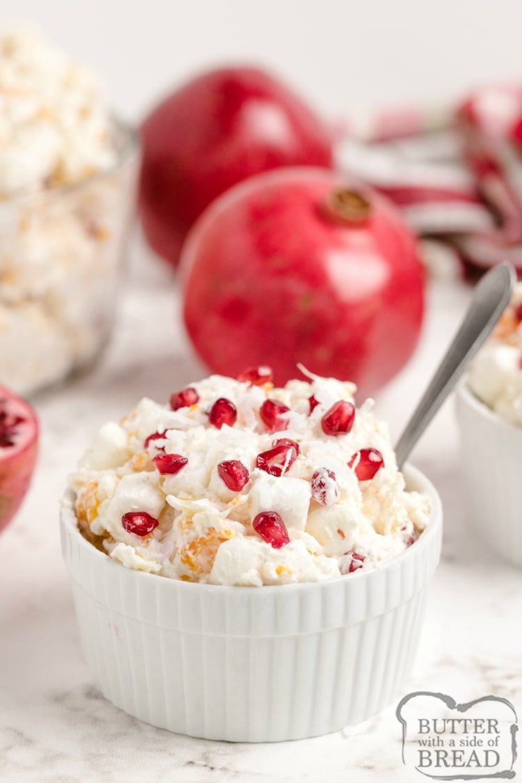 Creamy Pomegranate Fruit Salad made with pomegranates, fruit and marshmallows is sure to become a favorite holiday side dish! This simple fruit salad recipe is perfect for fall - it's been a family tradition to serve this for Thanksgiving for many years!