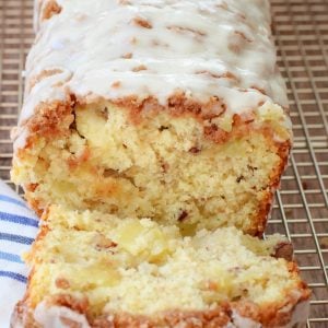 Dutch Apple Bread made from scratch with butter, sugar & fresh apples. Amazing flavor in this apple quick bread recipe topped with a cinnamon streusel & drizzled with warm vanilla glaze.
