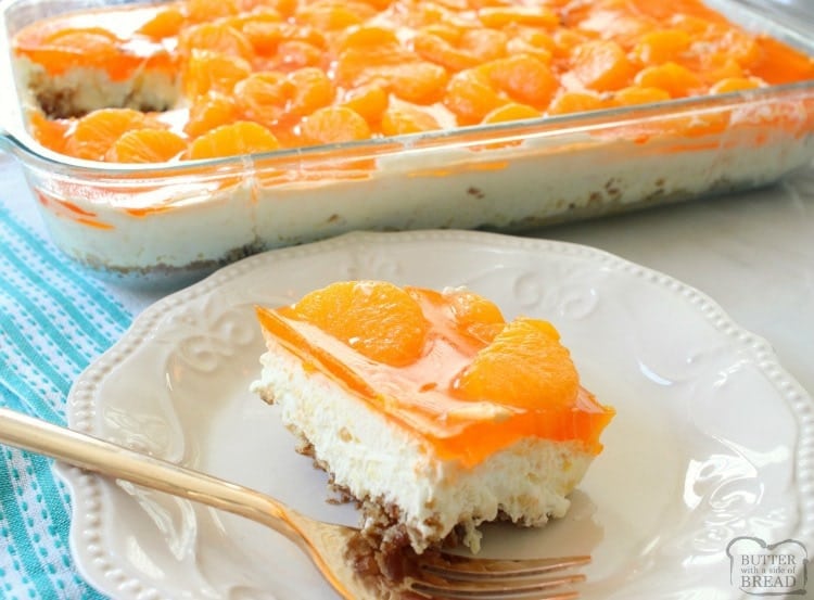 Tropical Jello Pretzel Salad is a combination of orange, pineapple and coconut flavors all in an easy-to-make sweet salad recipe!