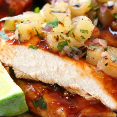 Grilled BBQ Chicken with Pineapple Salsa is made by smothering grilled chicken with thick & flavorful bbq sauce then topping it with a delicious pineapple salsa. Perfect for weeknight dinners or weekend get-togethers, the pineapple salsa pairs perfectly with the tangy grilled barbecue chicken.