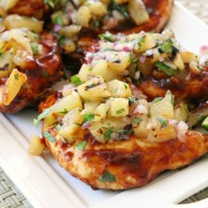 Easy Grilled Chicken smothered with thick & flavorful bbq sauce then topped with a delicious pineapple salsa is what's for dinner! Perfect for weeknight dinners or weekend get-togethers, the pineapple salsa pairs perfectly with the tangy grilled barbecue chicken.