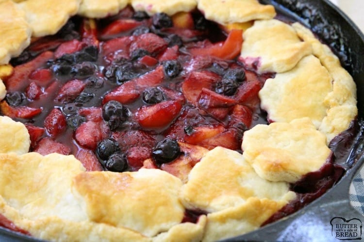 Easy Berry Peach Pie is the perfect summer pie recipe! Simple to make with an easy crust & filled with sweet fresh fruit then topped with vanilla ice cream.