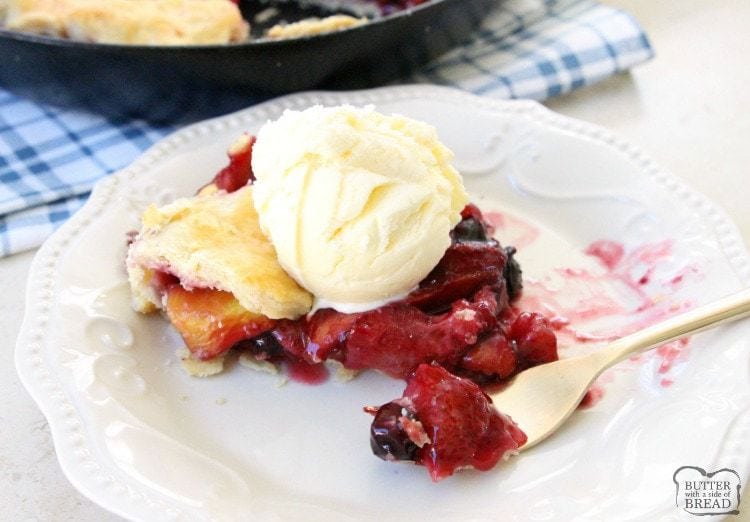 Easy Berry Peach Pie is the perfect summer pie recipe! Simple to make with an easy crust & filled with sweet fresh fruit then topped with vanilla ice cream.