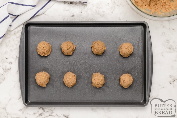 Butterfinger cookie dough balls on a cookie sheet