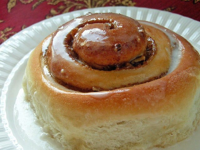 Cinnamon Rolls made from scratch that yields feather-light sweet rolls with pecans, cinnamon and a lovely vanilla glaze. Best cinnamon roll recipe ever tried!