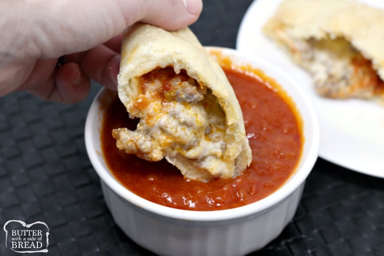 Cheesy Italian Sausage Calzones are made with a homemade pizza crust that is filled with parmesan, mozzarella, ricotta, marinara sauce and Italian sausage. These homemade calzones can be filled with any of your favorite meats and vegetables.