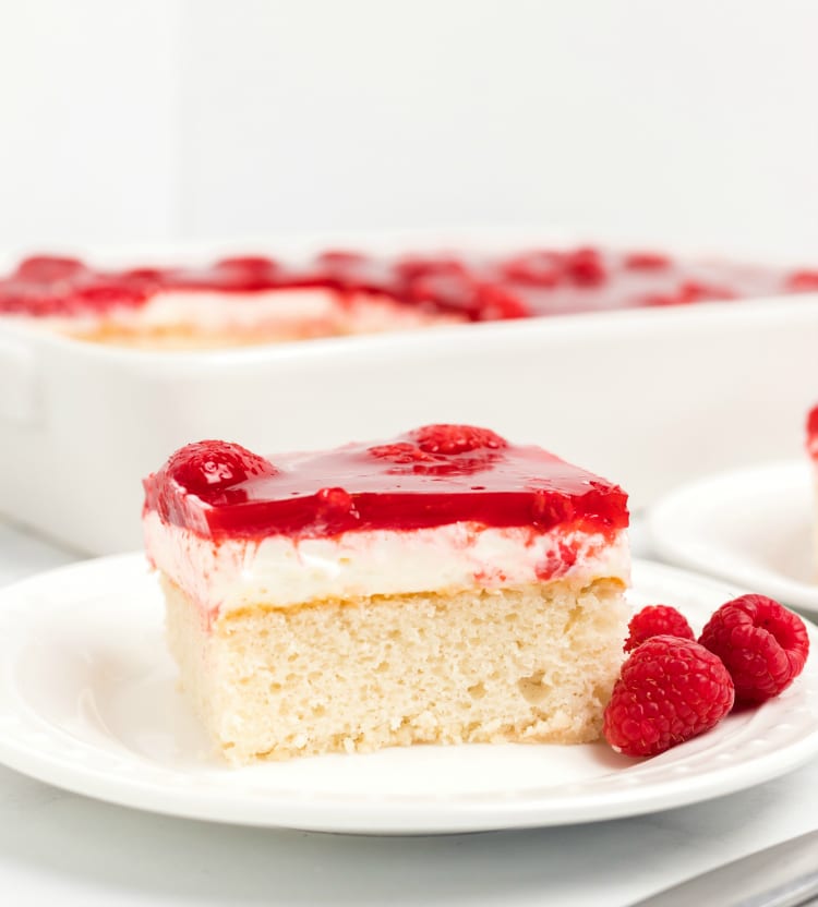 White cake mix with whipped cream and glazed raspberries on top