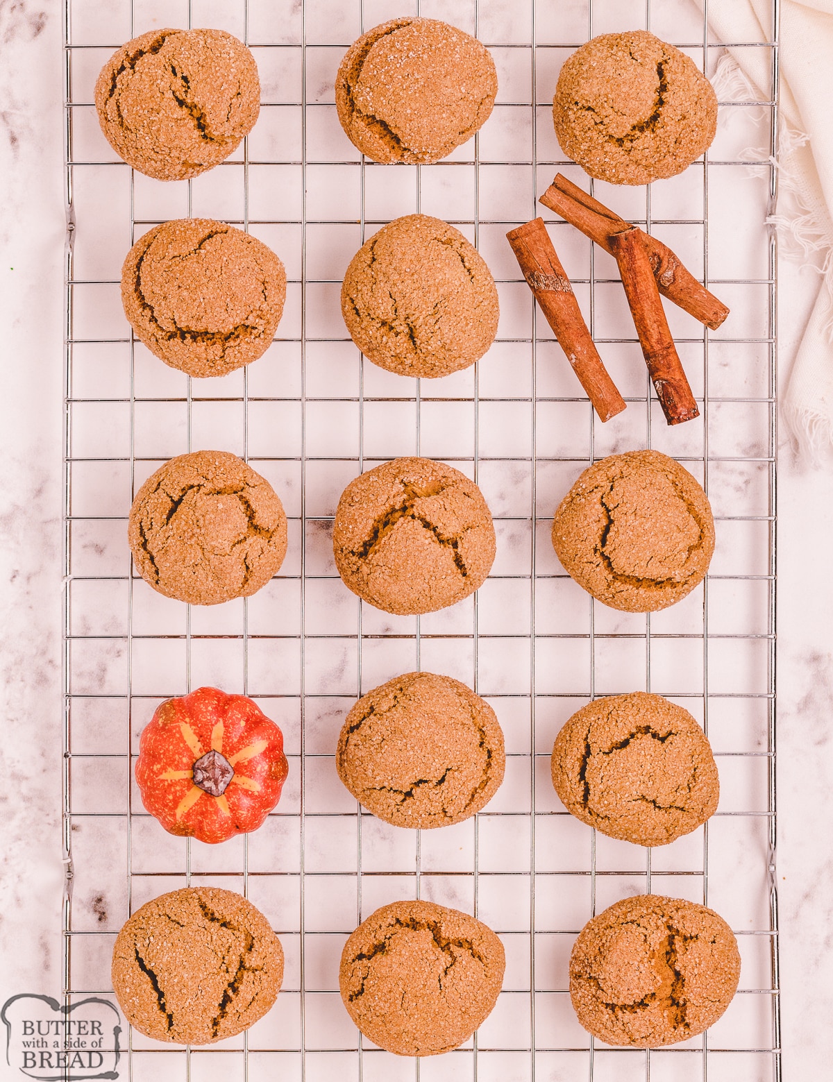 gingersnap cookies with pumpkin on a cooling rack
