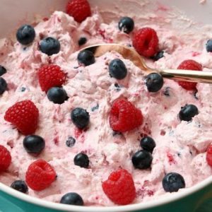 Berries and Cream Salad made using just 4 ingredients! Raspberries & Blueberries combine with Greek Yogurt, pudding mix and whipped topping to create a lovely berries and cream salad.