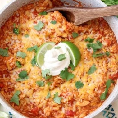 Cheesy Chicken & Spanish Rice is a quick & easy weeknight meal! Great flavor in this comforting One-Pot Spanish Rice recipe with added chicken and cheese. Can be made on the stove or in an Instant Pot!