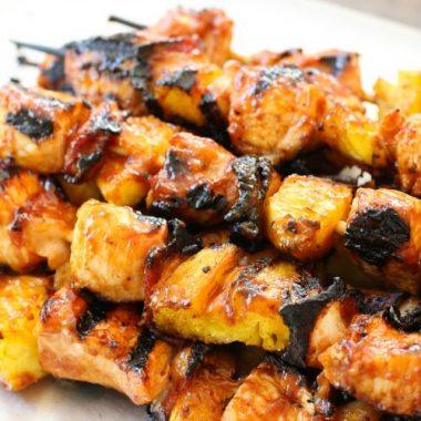 BBQ Chicken Kabobs recipe with tender chicken grilled with pineapple and bacon then slathered with your favorite BBQ sauce. These ultimate BBQ recipe for grilled chicken kabobs are perfect for your next cookout!