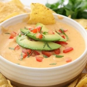 Easy Nacho Cheese sauce recipe with only 4 ingredients and is made in minutes! Smooth, creamy with great nacho cheese flavor, this recipe is perfect for parties, busy weeknight dinners and game day food!