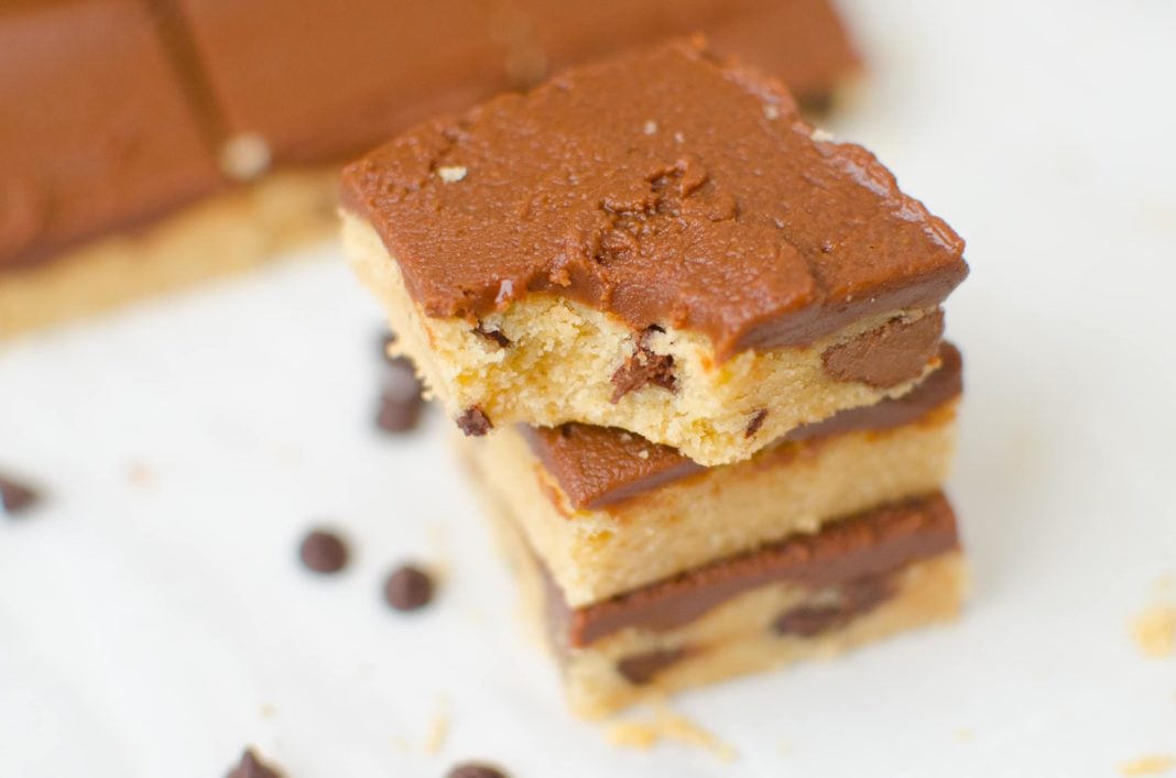 Peanut Butter Chocolate Chip Cookie Bars are made with soft sugar cookie dough mixed with peanut butter and chocolate chips. The bar is finished off with a creamy chocolate frosting to create the ultimate peanut butter chocolate chip cookie experience.