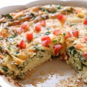 Crustless Spinach Quiche recipe that's quick & easy and tastes absolutely delicious! Packed with protein from milk, cheese and eggs, this easy quiche recipe also has spinach and fresh tomatoes. Serving crustless quiche makes prep so much easier, plus the quiche is healthier for you.