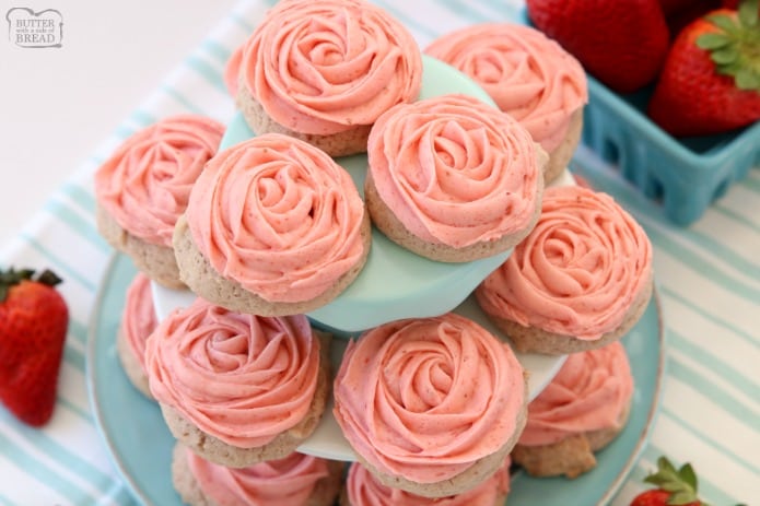 Frosted Strawberry Cookies made by adding fresh strawberries to a simple sugar cookie dough. No rolling out or chilling necessary! Just bake and top with my amazing strawberry buttercream frosting. Easy Strawberry Cookies piped with a super simple pink rose, so they taste incredible and they’re pretty too!