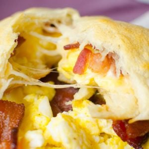 Canned crescent roll dough baked with scrambled eggs, bacon and cheese inside to make a convenient breakfast.