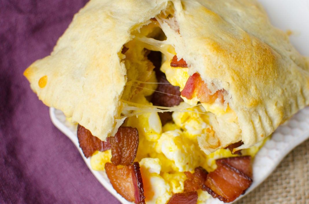 Bacon, Egg and Cheese Breakfast Pockets are full of fluffy scrambled eggs, bacon bits, and melted cheese wrapped up and baked in canned crescent roll dough. These Breakfast Pockets are both easy and delicious. Not to mention, they are freezer friendly and make a great breakfast on the go!