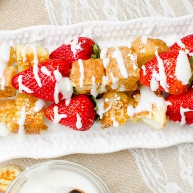 French Toast Kabobs are French toast bites stacked onto a kabob with fresh, ripe strawberries drizzled with a vanilla glaze.