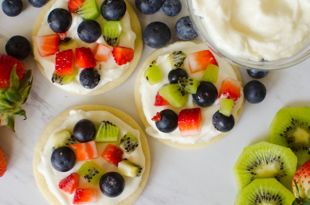 Sugar Cookie Fruit Pizzas made with an easy cookie base and topped with homemade frosting and chopped fresh fruit. 