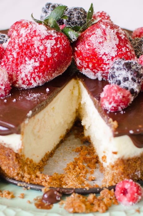 Cheesecake with Berries & Chocolate Ganache is a creamy, homemade, six-inch cheesecake topped with a rich chocolate ganache. The Cheesecake is garnished with sugared berries that give this classic dessert a bright, fresh flavor. 