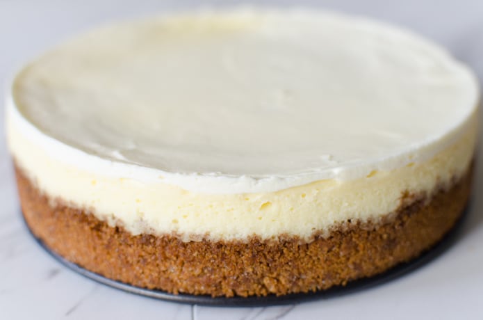 The sour cream layer of this cheesecake is visible in this photo seen as the bright white top layer.