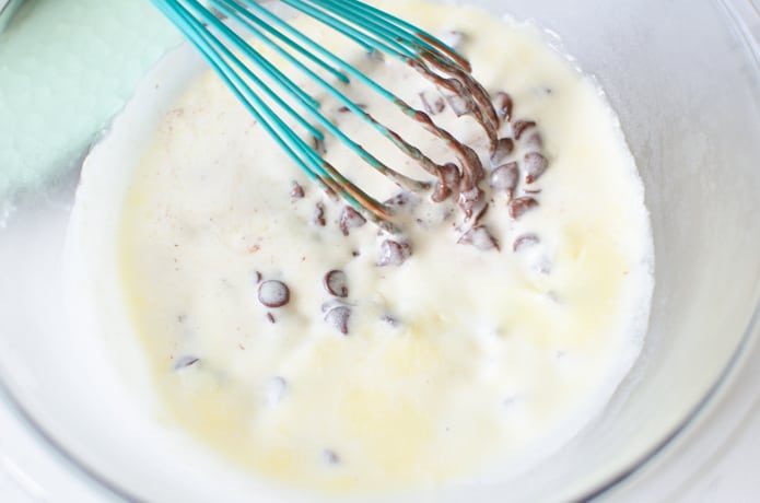 Melted butter and cream are mixed with chocolate chips to create a chocolate ganache.