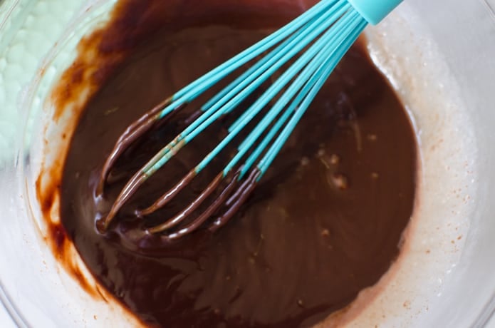 After mixing, the chocolate ganache is ready to be poured onto the cheesecake.