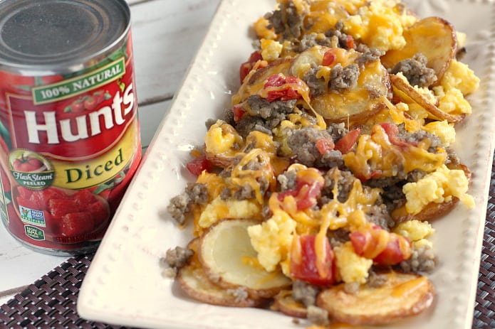 Breakfast Nachos are perfect for breakfast, but also make a wonderful lunch or dinner too! Thinly sliced roasted potatoes topped with sausage, scrambled eggs, cheese and tomatoes - an easy meal that can be ready in 30 minutes!