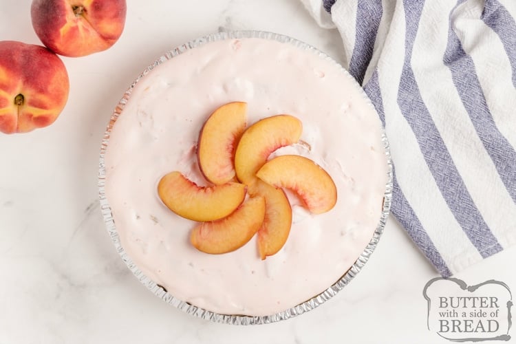 Creamy Peach Pie is made with only 5 ingredients in only a few minutes! Peach Jell-O, vanilla ice cream and fresh peaches are combined into a delicious, no-bake pie recipe! 