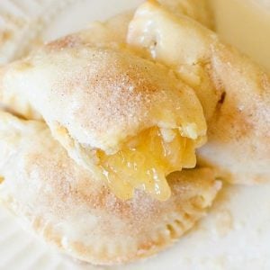 Apple Hand Pies are mini apple pies, no utensils needed! All the flakey crust and cinnamon apples wrapped up in a vanilla glaze held right in the palm of your hand. This will be the easiest, tastiest Hand Pie recipe you'll find!