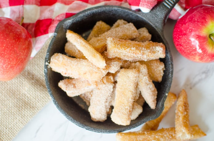 Apple Pie Fries are small strips of apple pie with a flaky crust and a simple applesauce filling. The Apple Pie Fries are fried and then tossed in cinnamon and sugar to complete this sweet, Fall time dessert.