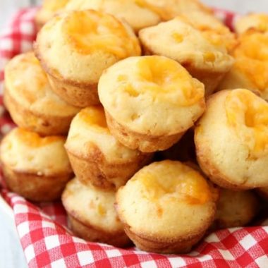 Cheesy Cornbread Muffins are delicate, flavorful honey cornbread with a cheddar cheese addition! Fun, bite-sized mini cornbread muffins are perfect for accompanying lunch or dinner any time of the year!
