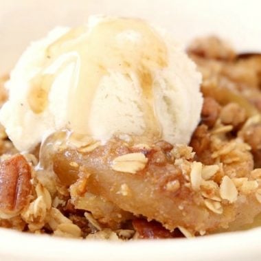 Maple Pecan Apple Crisp made with oats, pecans, brown sugar, butter and apples in a perfect Fall dish bursting with fresh apple flavor! Topped with real maple syrup, this apple crisp recipe is our all-time favorite!