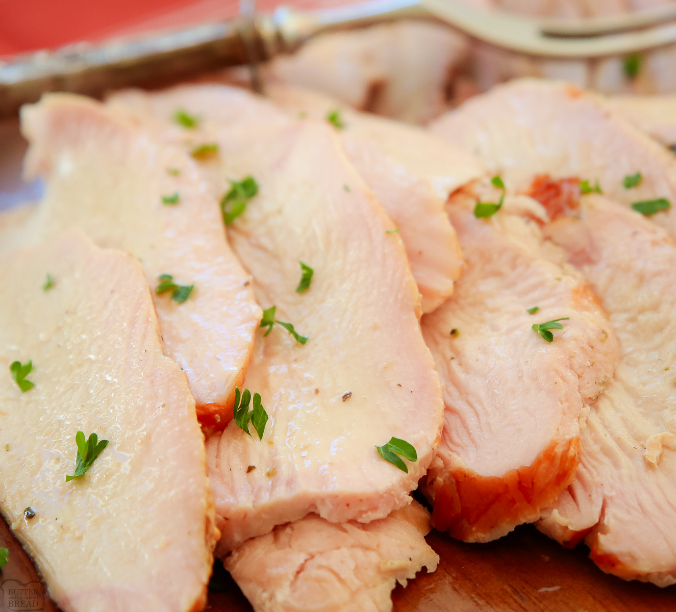 juicy slices of smoked turkey on a wooden platter