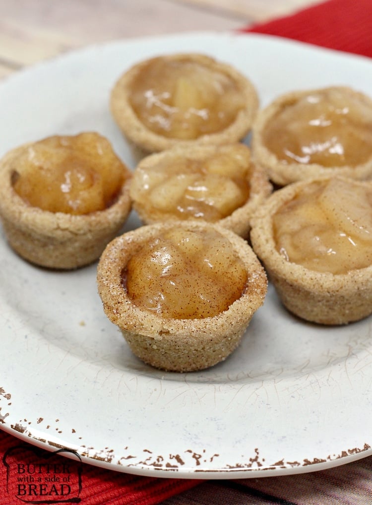  Snickerdoodle Apple Pie Cookie Cups combine two favorite desserts in a bite sized treat! Mini apple pies with a delicious, homemade snickerdoodle cookie crust! 