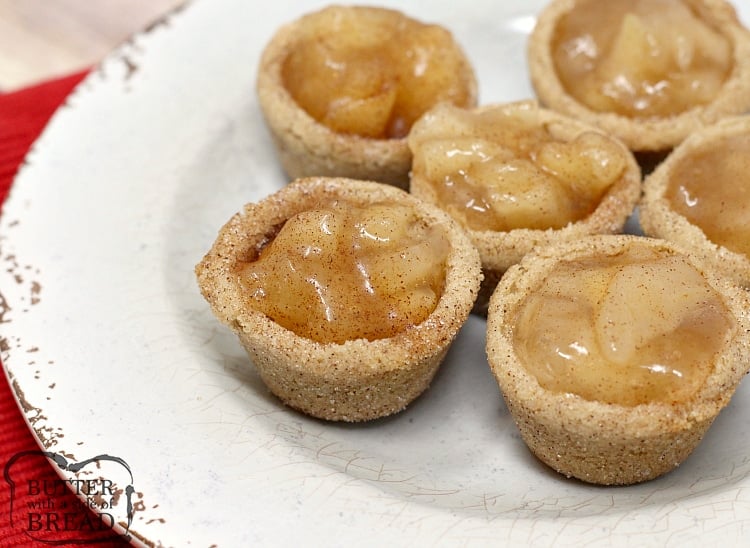  Snickerdoodle Apple Pie Cookie Cups combine two favorite desserts in a bite sized treat! Mini apple pies with a delicious, homemade snickerdoodle cookie crust! 