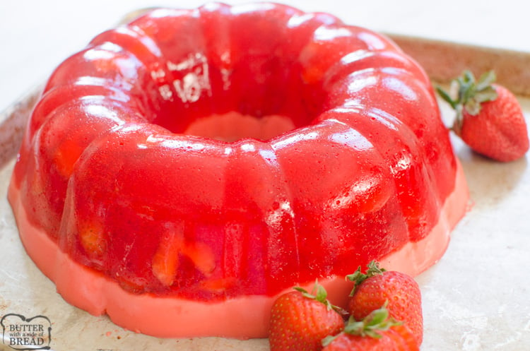 Strawberry Jello Mold is a fun way and delicious way to serve jello salad. The jello is set in a bundt pan & has two layers, fresh strawberries in jello and a creamy sweet jello bottom layer! Perfect way to serve a fancy jello treat!