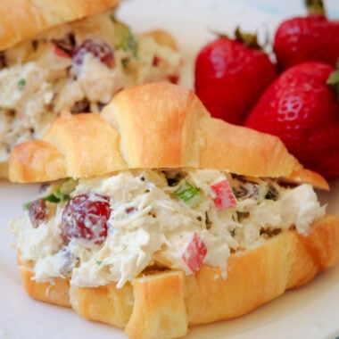 chicken salad with apples, grapes and celery served in a croissant