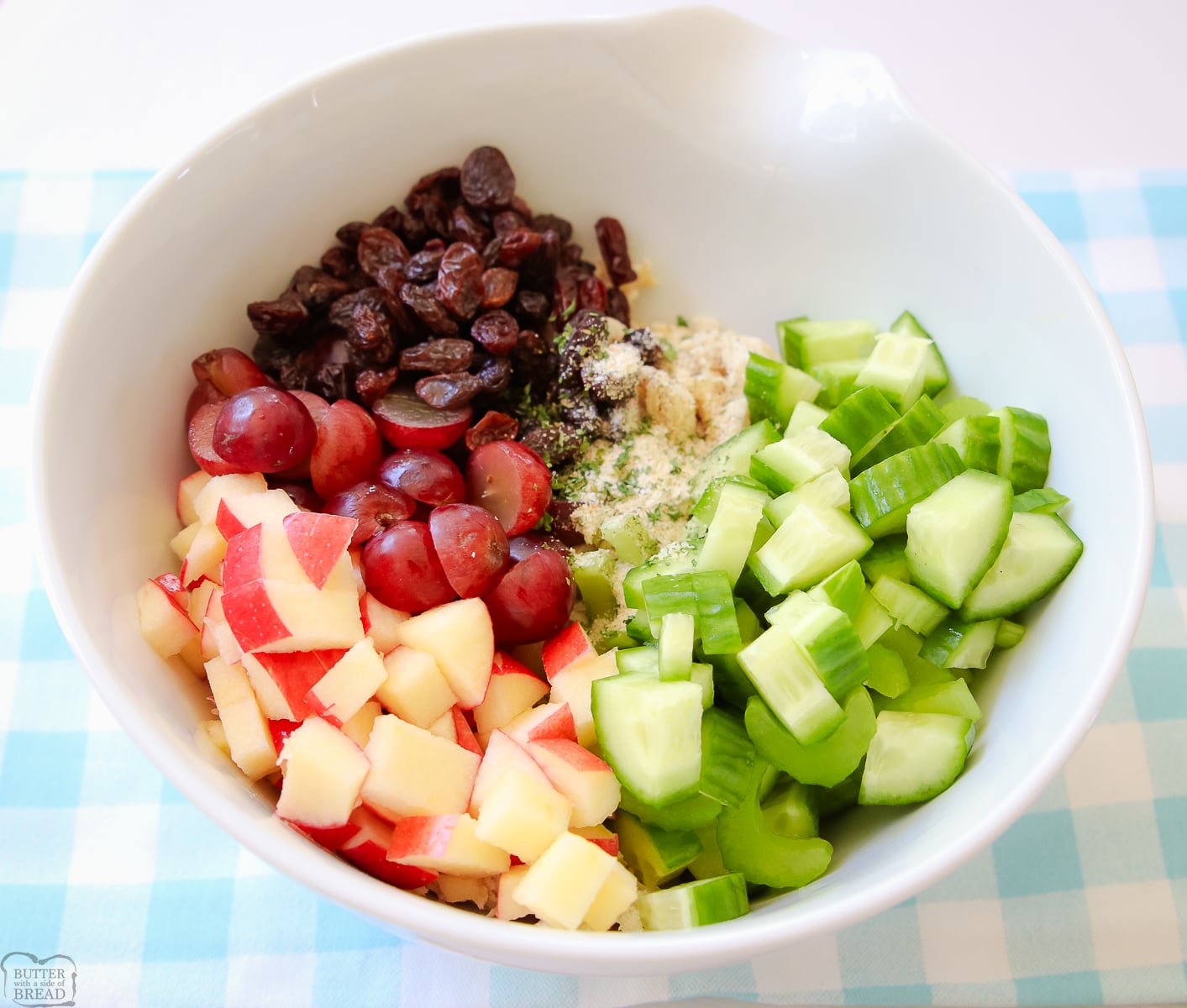 apple, celery, grapes and raisins in a bowl for making chicken salad