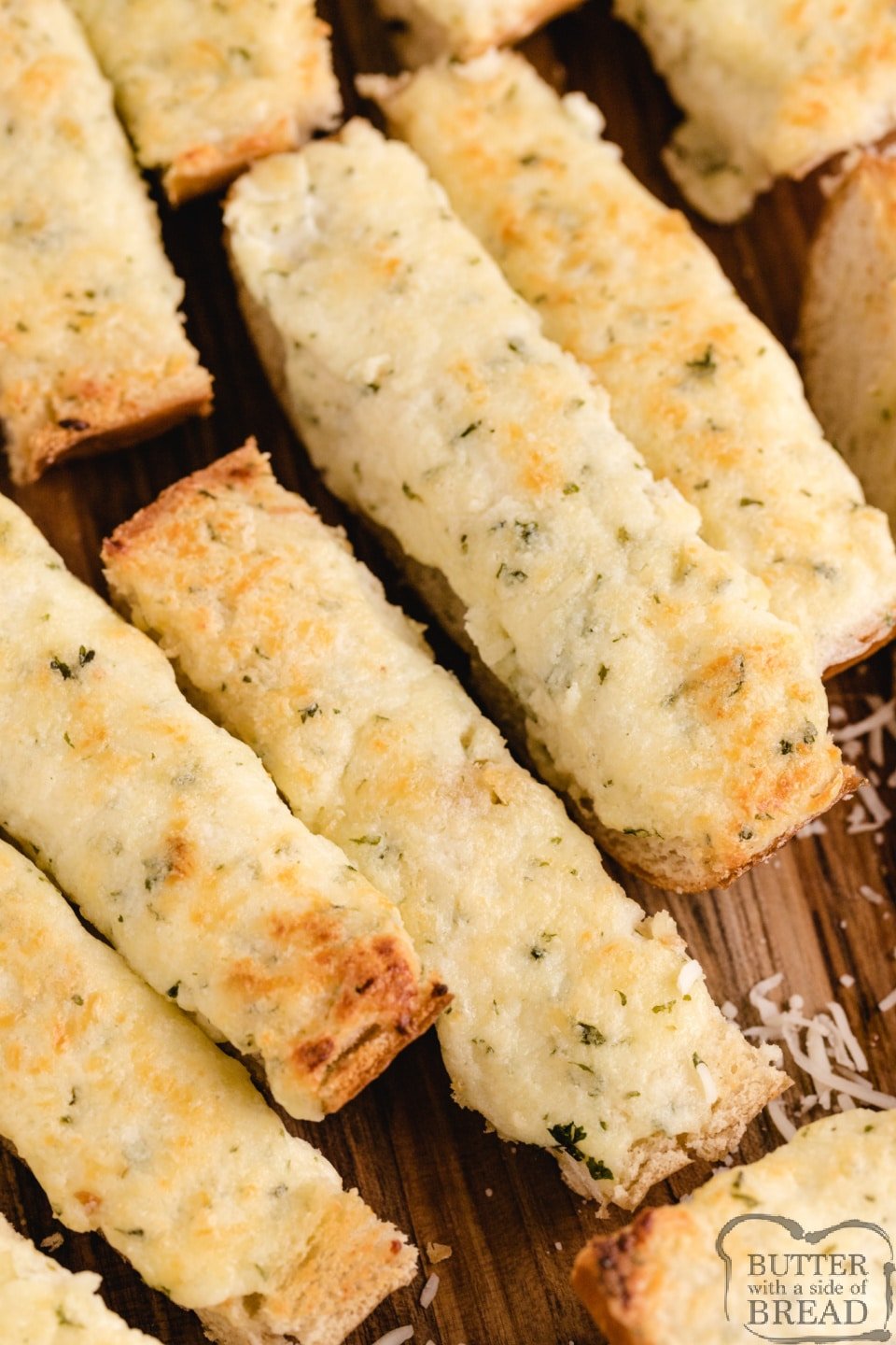 Easy Cheesy Garlic Bread is loaded with butter, cream cheese, garlic, parsley and mozzarella- it's the perfect side dish for every Italian meal! Perfectly seasoned and loaded with cheese, this garlic bread recipe can be made and served in under 10 minutes! 