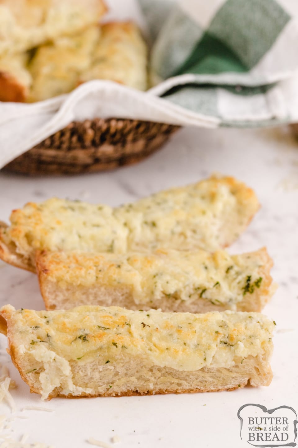 Easy Cheesy Garlic Bread is loaded with butter, cream cheese, garlic, parsley and mozzarella- it's the perfect side dish for every Italian meal! Perfectly seasoned and loaded with cheese, this garlic bread recipe can be made and served in under 10 minutes! 