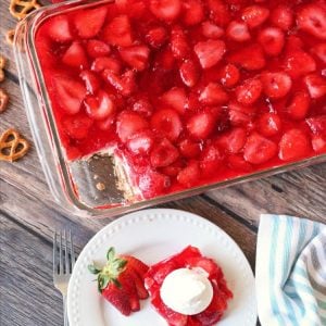 Gorgeous Strawberry Pretzel Salad layered with a buttery pretzel crust, cream cheese whipped topping, strawberries and jello. A simple sweet side dish that is always the first to go!