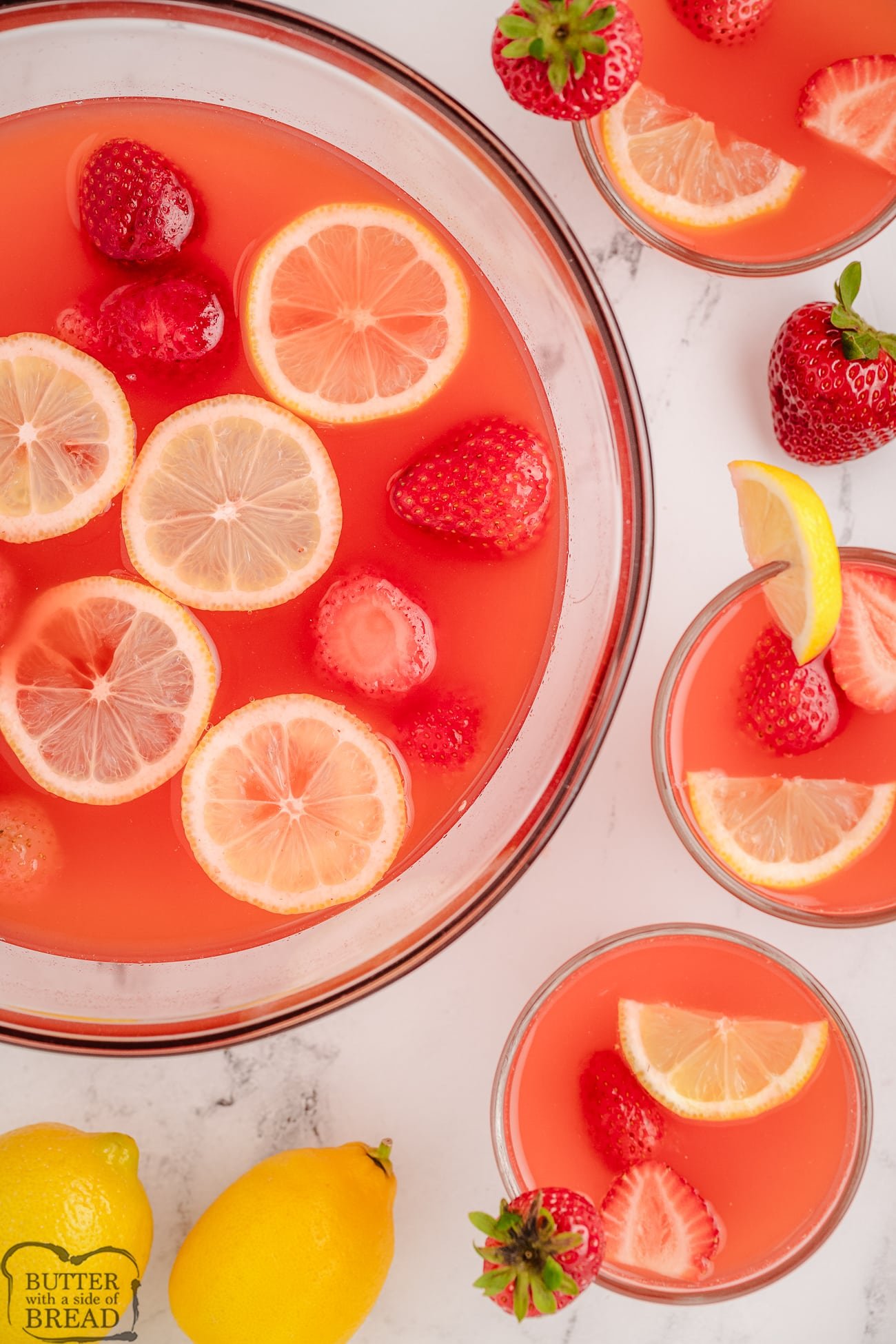 punch bowl and glasses filled with easy Strawberry Lemonade