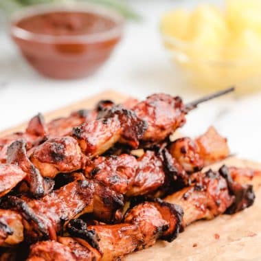 BBQ sauce on chicken kabobs with pineapple and bacon