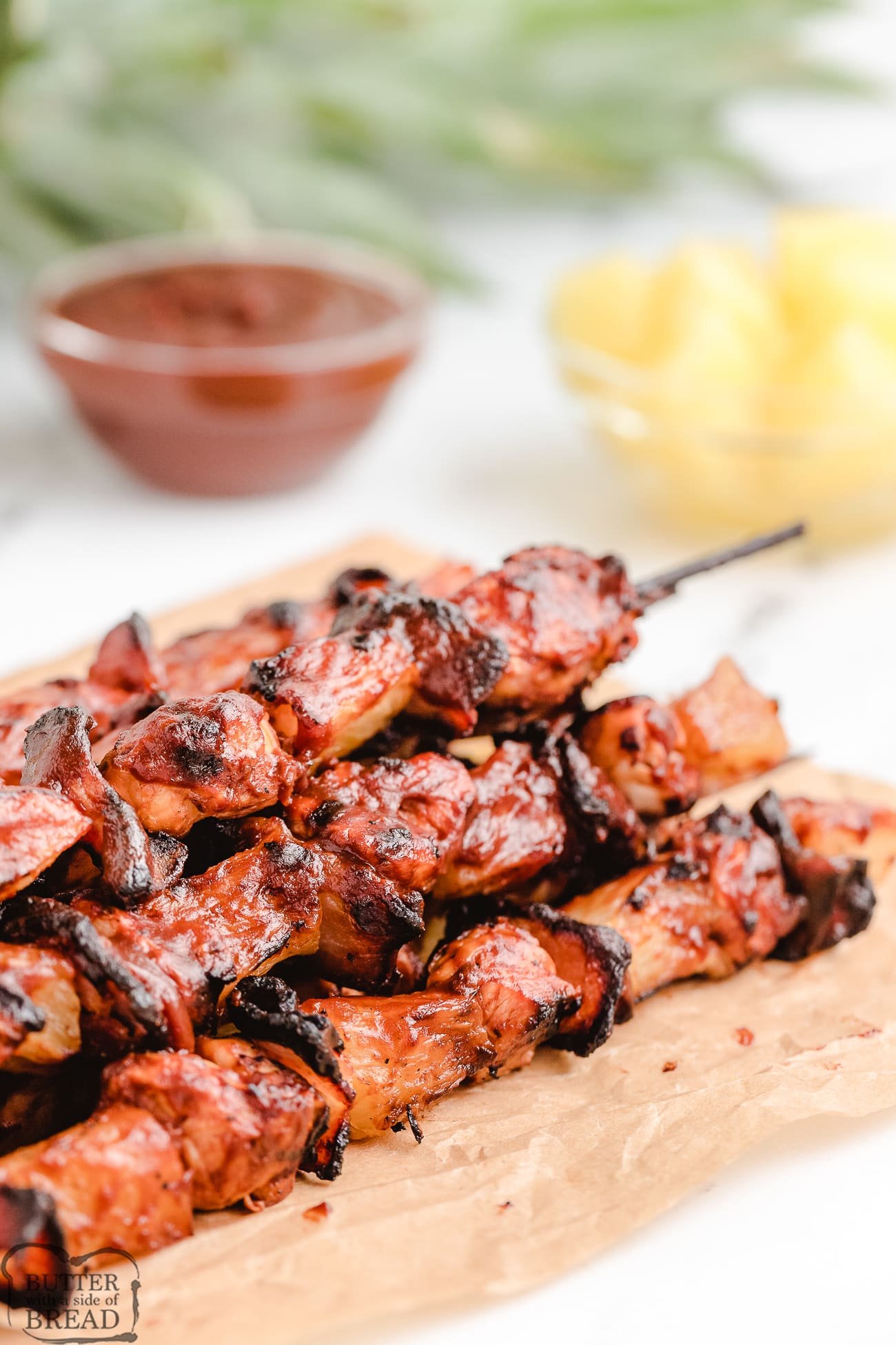 BBQ sauce on chicken kabobs with pineapple and bacon