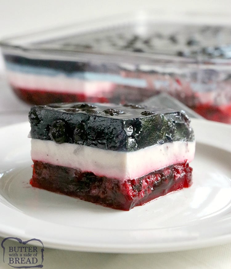 Patriotic Layered Jello Salad has a raspberry layer and a blueberry layer with a delicious vanilla layer in between! This red, white and blue dessert is perfect for the 4th of July and is so yummy, you'll want to eat it the rest of the year too!