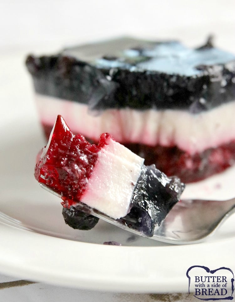 Patriotic Layered Jello Salad has a raspberry layer and a blueberry layer with a delicious vanilla layer in between! This red, white and blue dessert is perfect for the 4th of July and is so yummy, you'll want to eat it the rest of the year too!